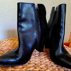 Black faux snake skin fashion bootie. 3” heel. Inside zipper. Women’s size 7.